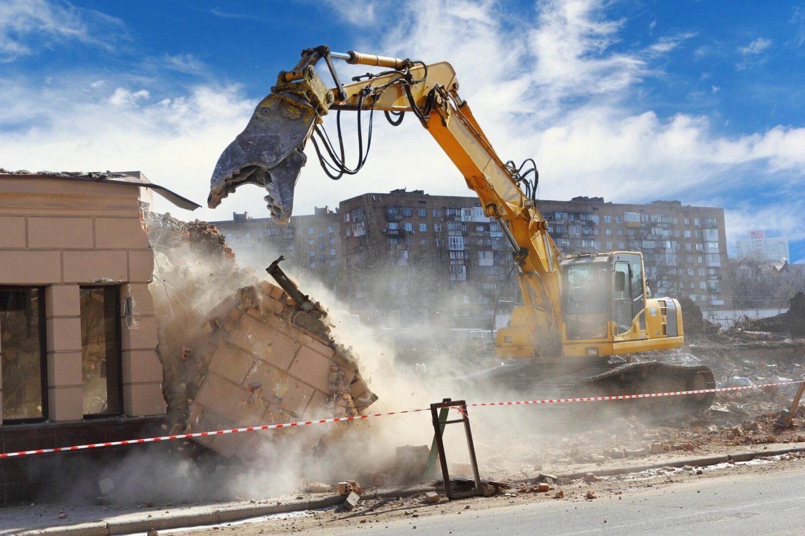 A yellow and black excavator is on the road
